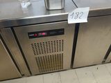 a stainless steel refrigerator with a glass of water on top of it