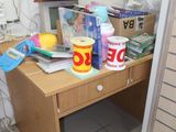 a wooden desk with a lot of items on it