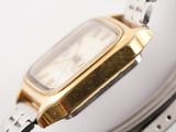 a close up of a watch on a white surface