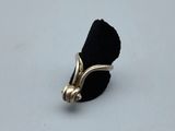 a close up of a ring on a white surface with a black cloth