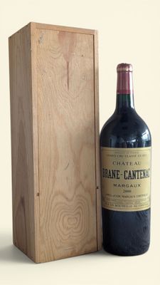 a bottle of wine sitting next to a wooden box