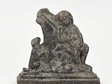 statue of a man and a dog sitting on a rock