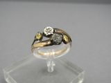an image of a gold and diamond ring on a clear stand