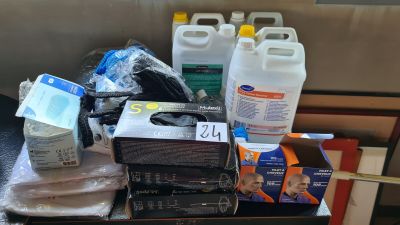 a pile of cleaning supplies on a table next to a couch