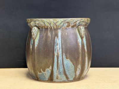 a close up of a vase on a table