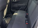 the back seats of a white car with black trims and a black seat belt