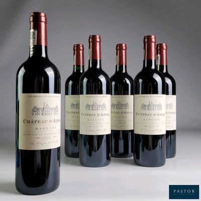 four bottles of red wine are lined up on a table