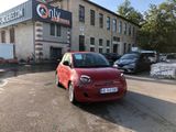 a small red car parked in front of a building