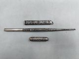 three different types of pens and a pen on a table