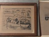 two framed pictures of boats on display on the wall