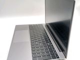a laptop computer sitting on top of a white table