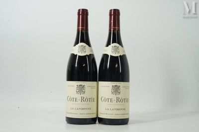two bottles of red wine sitting on top of a white table