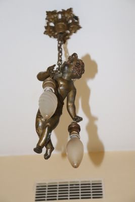 a statue of a man holding a light bulb in his hand