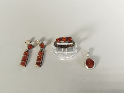 several pieces of jewelry sitting on top of a white surface