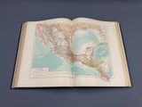 an open book with a map of mexico on it on a table