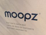 the back of a bag with a logo on it that says moopz