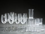 a lot of wine glasses that are sitting on a table