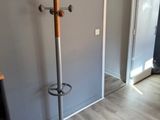 an image of a coat rack in the corner of a room
