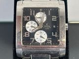 a close up of a watch on a black surface