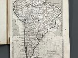 an open book with a map of south america on it
