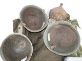 three helmets are sitting on a table next to a bag