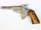 a small gun that is on a white surface