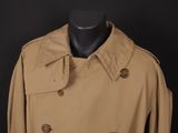 a close up of a tan trench coat on a mannequin dummy