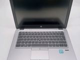 a laptop computer sitting on top of a white table