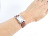a woman ' s hand with a watch on her wrist