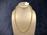 a gold necklace on a mannequin with a tag on it