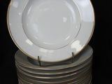 several plates stacked on top of each other on a black surface