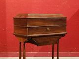 a small wooden table with a drawer on it