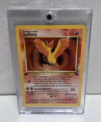 a close up of a pokemon card in a plastic holder