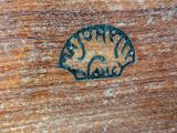 a close up of a piece of wood with a small animal on it