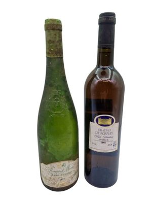 two bottles of wine sitting next to each other on a white surface