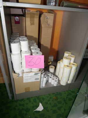 several rolls of toilet paper are stacked on a shelf in a room