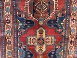an oriental rug hanging on a wall in a room