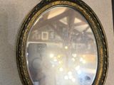 a mirror hanging on the wall next to a clock