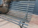 a statue of a person sitting on a bench