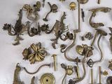 a lot of antique brass items on a white surface
