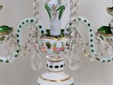 a glass candle holder with a green and white design on it