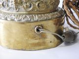 a metal container with a rope around it on a white surface