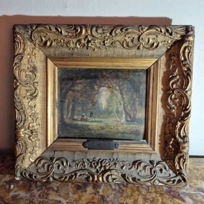 un vieux cadre contenant le portrait d'une femme dans un paysage
