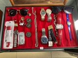 a suitcase full of assorted watches and other items