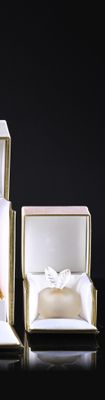 two boxes with wedding rings in them sitting on a table