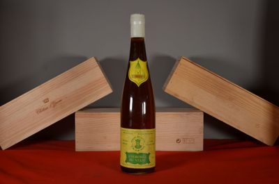 a bottle of wine sitting on a table next to a box