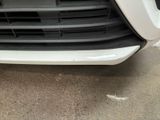 a close up of the front bumper of a white car