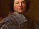 portrait of a man in a blue robe holding a cross