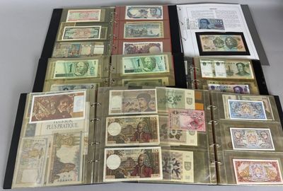 several different types of paper money are displayed on a table