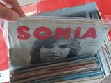 a person that is opening a box with some records in it